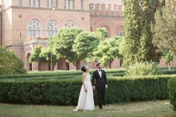 Wedding Photographer in Italy: Happy bride and groom walking in the park holding hands