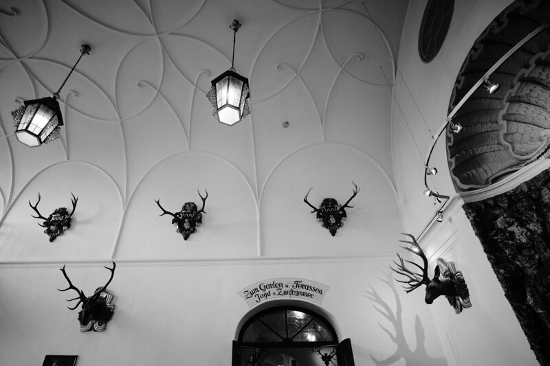 Wedding photography portfolio in Italy: Deer horns and large lanterns are hung on the ceiling and on the walls of the restaurant
