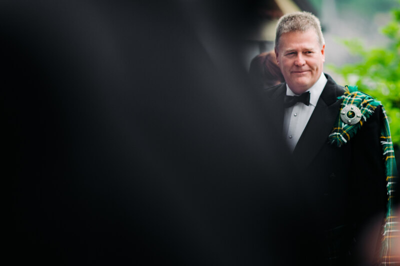 Wedding photography portfolio in Italy: Portrait of a handsome man in a black tuxedo with a national emblem on his shoulder