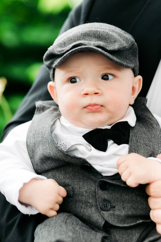 Wedding photography portfolio in Italy: Portrait of a little boy in a cap and a gray suit