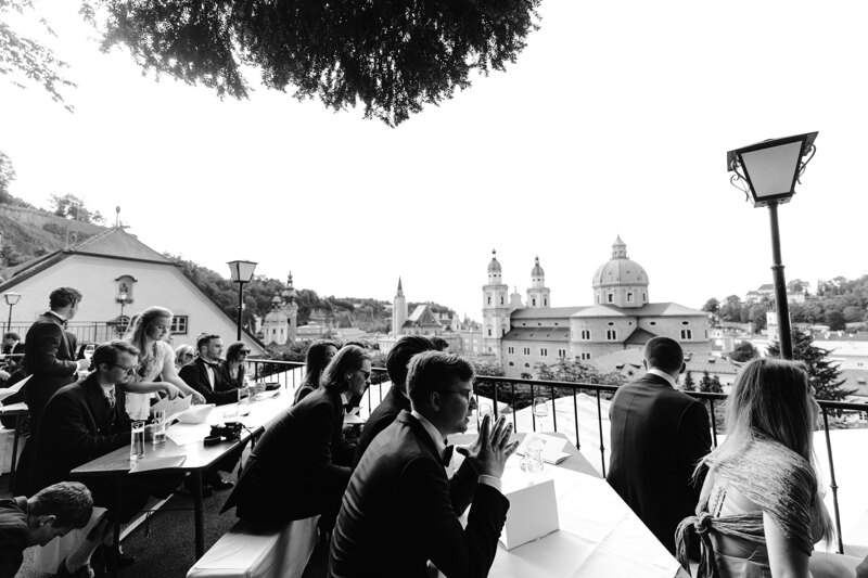 Wedding photography portfolio in Italy: Guests are sitting on the hotel terrace awaiting the start of the wedding