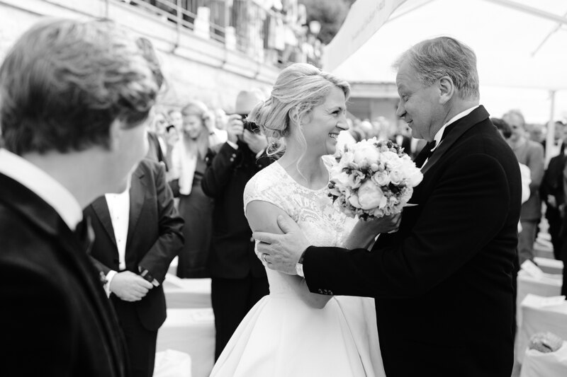Wedding photography portfolio in Italy: Father holds his daughter by her hands and congratulates on the marriage