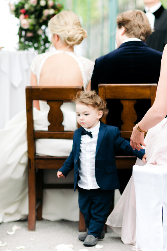 Wedding photography portfolio in Italy: Portrait of a little boy in a blue tuxedo at a wedding