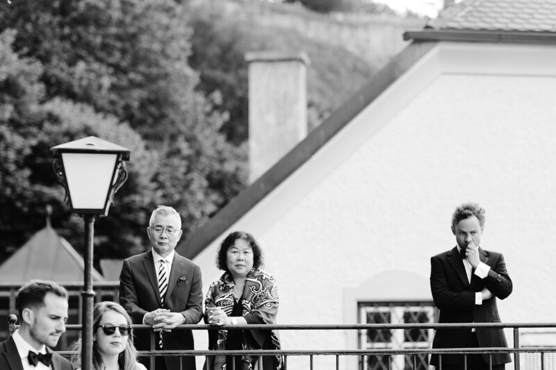 Wedding photography portfolio in Italy: Guests stand on the veranda and watch the wedding begin