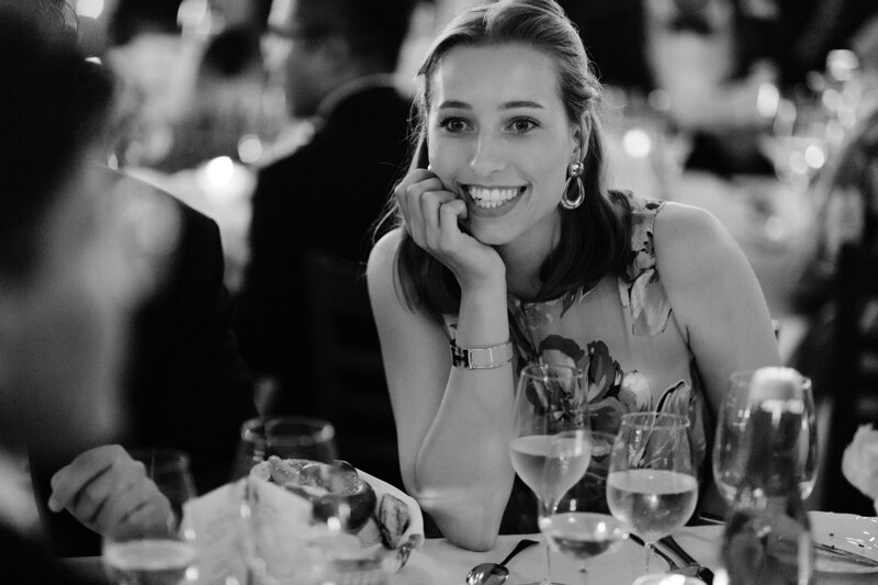 Wedding photography portfolio in Italy: Woman with a glass of champagne sits at a table