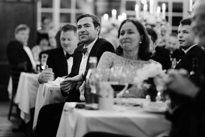 Wedding photography portfolio in Italy: Guests are sitting at a table in the festive hall