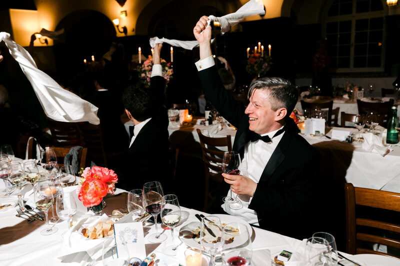 Wedding photography portfolio in Italy: Guests cheerfully wave white napkins above their heads