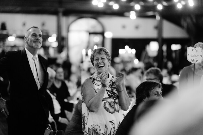 Wedding photography portfolio in Italy: Guest sincerely smiles and applauds while standing