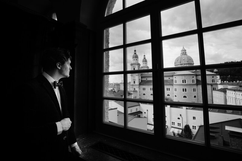 Wedding photography portfolio in Italy: Groom looks out the window