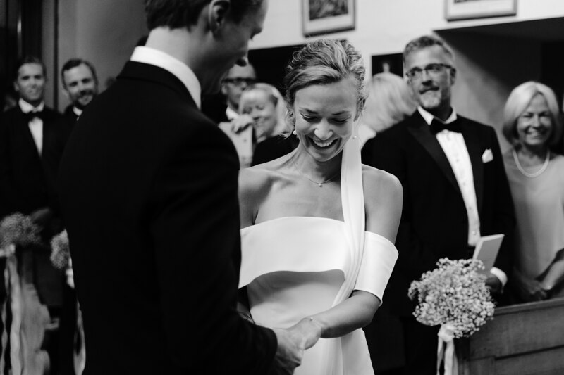 Wedding photography portfolio in Italy: The bride puts a ring on the finger of her beloved and sincerely smiles