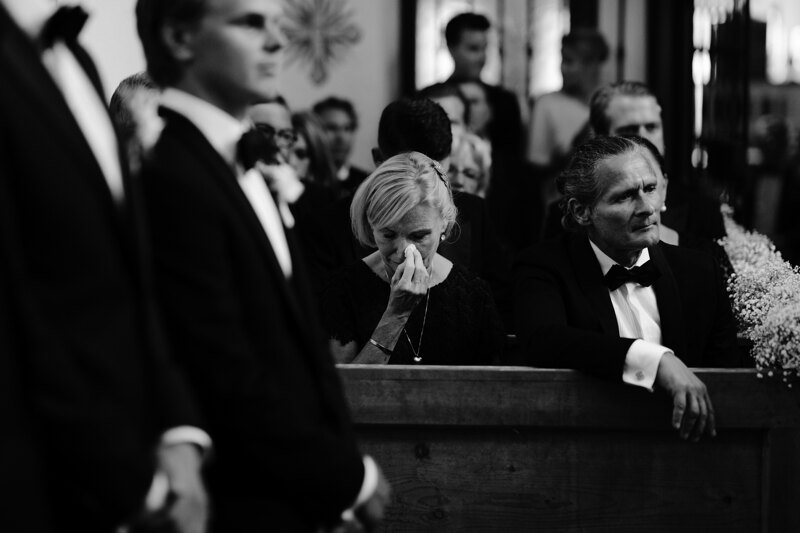 Wedding photography portfolio in Italy: The moment when a woman wipes her tears with a handkerchief at a touching ceremony