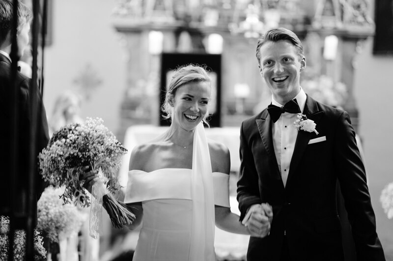 Wedding photography portfolio in Italy: Bride and groom holding hands, happy go out of church