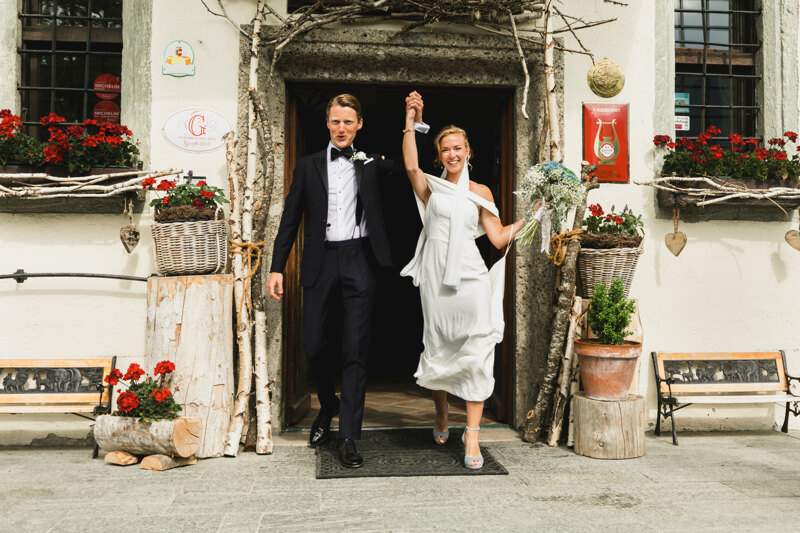 Wedding photography portfolio in Italy: Bride and groom happy leave the church holding hands