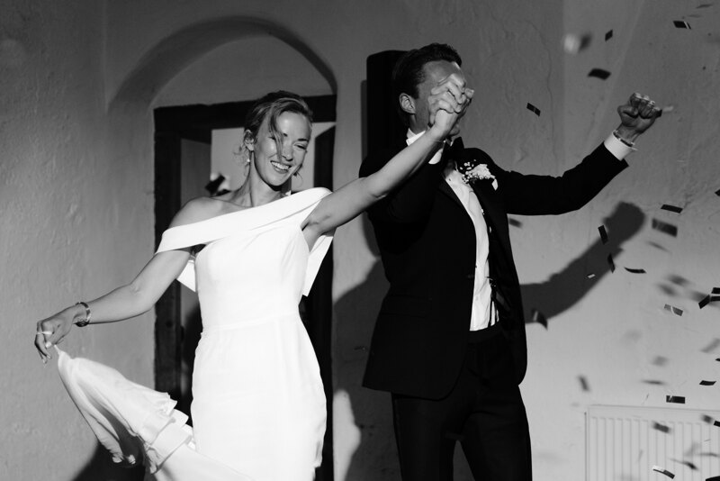 Wedding photography portfolio in Italy: Happy bride and groom go into the room holding hands