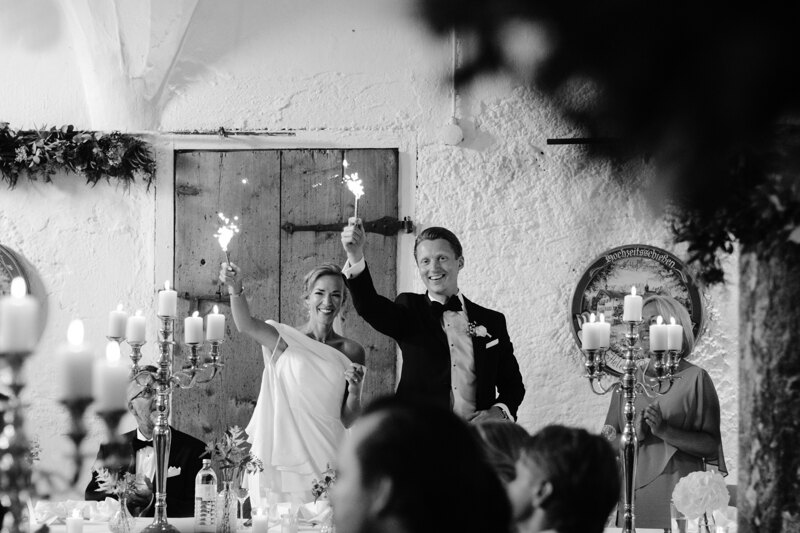 Wedding photography portfolio in Italy: Bride and groom holding fireworks in their hands