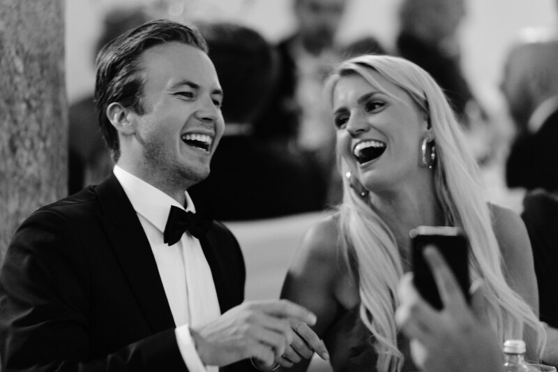 Wedding photography portfolio in Italy: Guests sincerely smile at the table