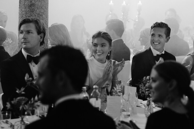 Wedding photography portfolio in Italy: Guests sincerely smile at the table