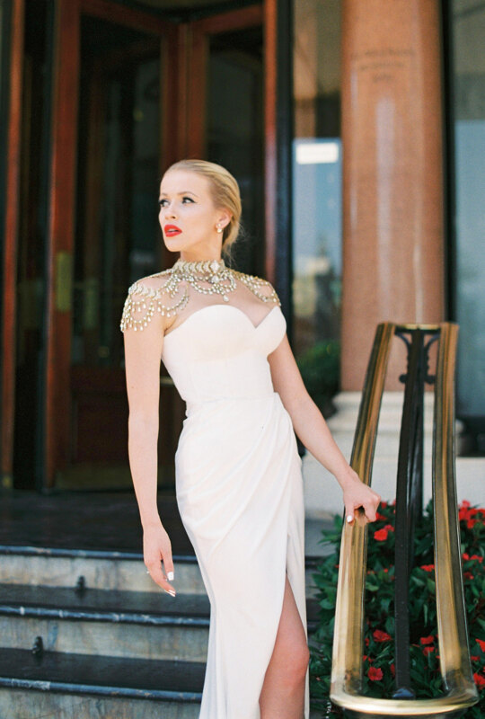 Wedding Photographer in Milan: Not a typical bride with bright red lipstick on her lips, she wears a luxurious designer dress embroidered with stones