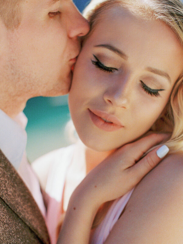 Wedding photography portfolio in Italy: The groom gently kisses his beloved, who closed her eyes from the pleasant touch of his lips