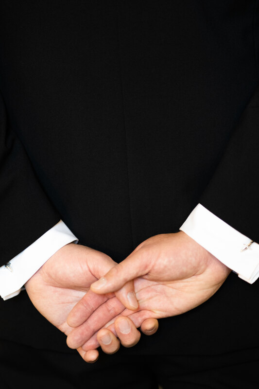 Wedding photography portfolio in Italy: Hands of the groom behind