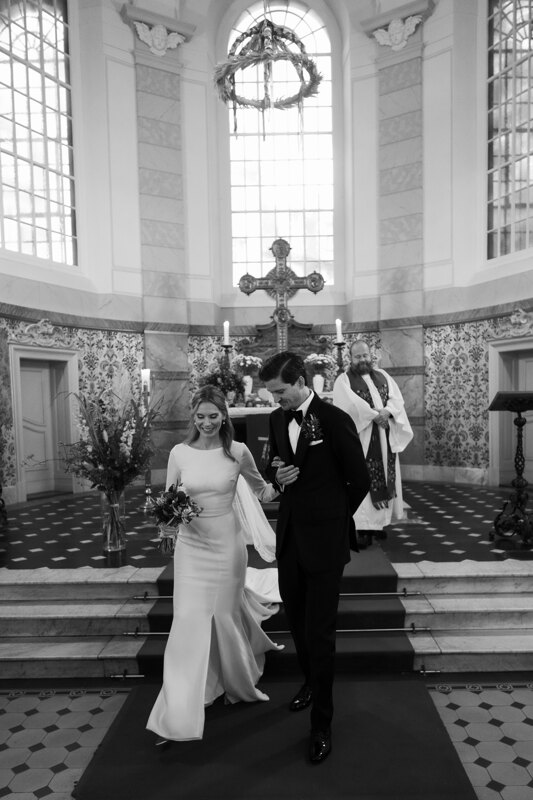 Wedding photography portfolio in Italy: The groom carefully supports his bride by the hand and together they go forward