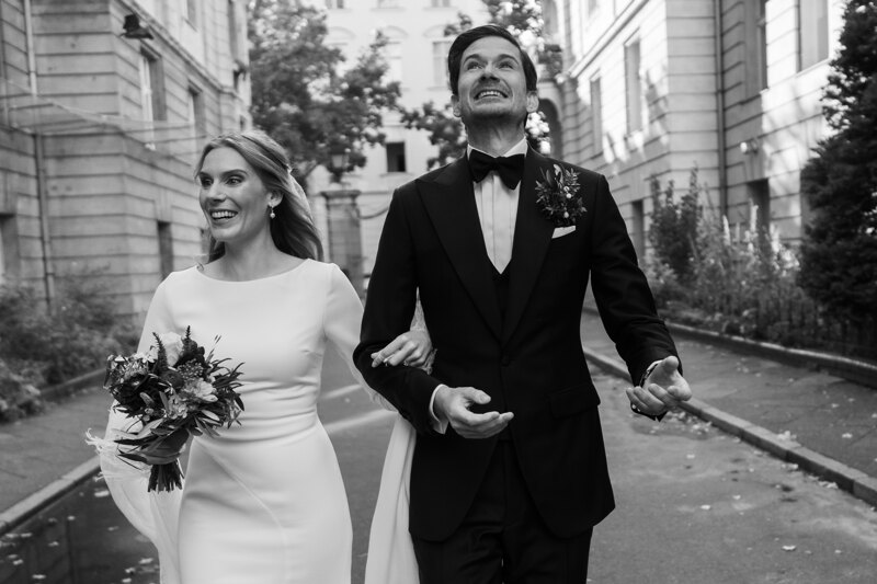 Wedding photography portfolio in Italy: Newlyweds newlyweds confidently step forward holding hands and smiling