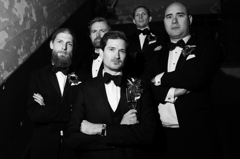 Wedding photography portfolio in Italy: Serious groom and his friends looking at the frame