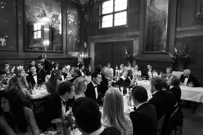Wedding photography portfolio in Italy: Respectable guests sit at guest tables in a large festive hall
