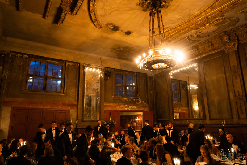 Wedding photography portfolio in Italy: Guests sit at guest tables at a wedding.