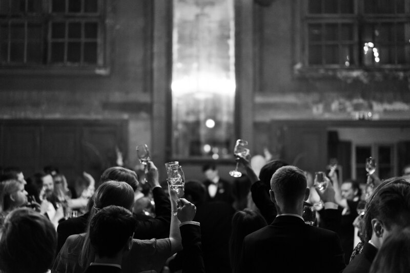 Wedding photography portfolio in Italy: Guests raise their glasses up for a young couple