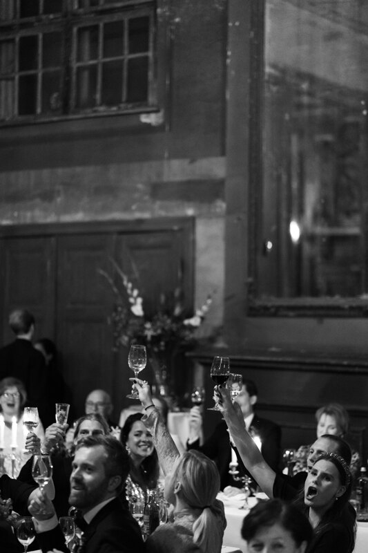 Wedding photography portfolio in Italy: Guests raise their champagne glasses up