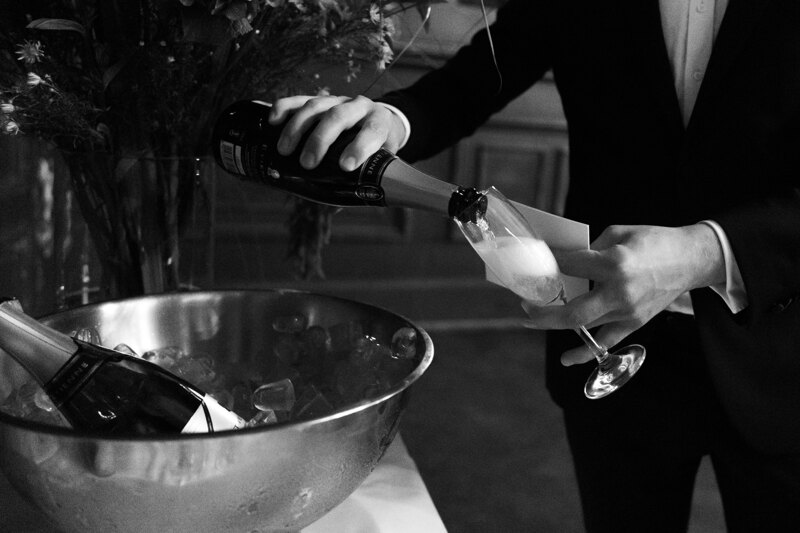 Wedding photography portfolio in Italy: A man pours champagne into a glass