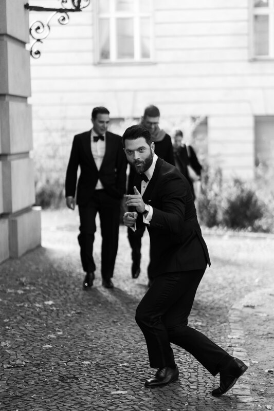 Wedding photography portfolio in Italy: Guest in a black tuxedo having fun posing on camera