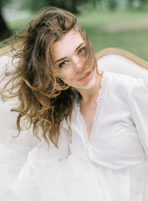 Couple photoshoot in Italy: The image of a tender bride, whose hair is neatly combed by the wind