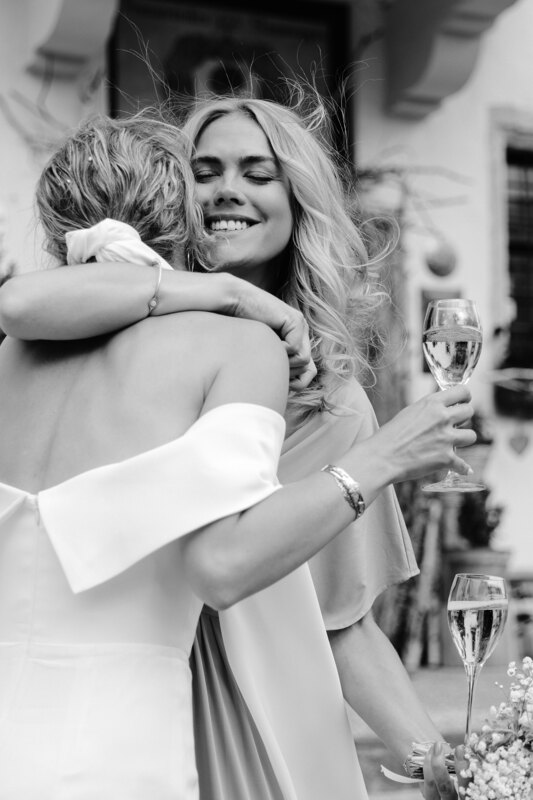 Wedding photography portfolio in Italy: Smiling girl hugs a bride