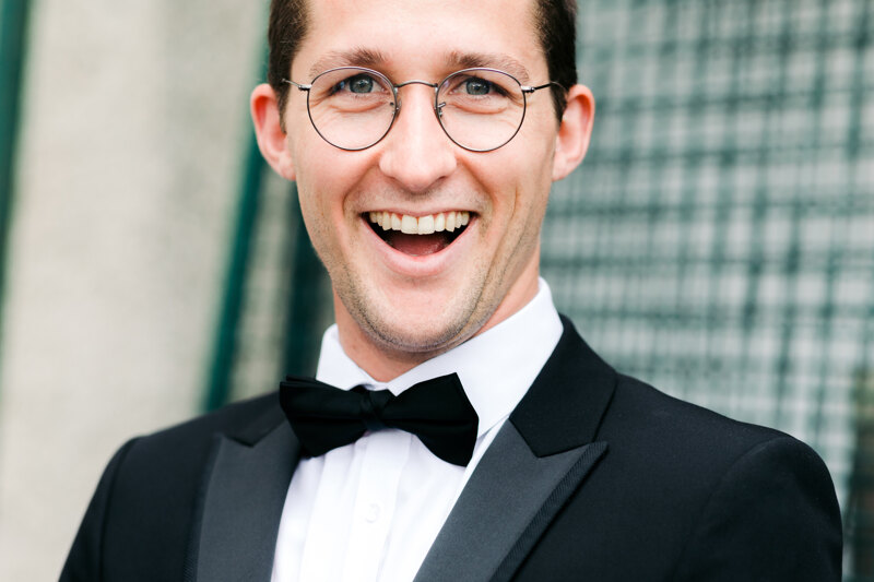  Wedding photography portfolio in Italy: Portrait of a happy and smiling groom with glasses and a bow tie