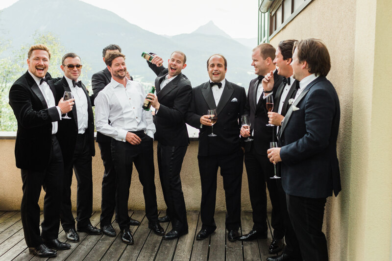 Wedding photography portfolio in Italy: Groom with his friends drinking champagne on the hotel terrace