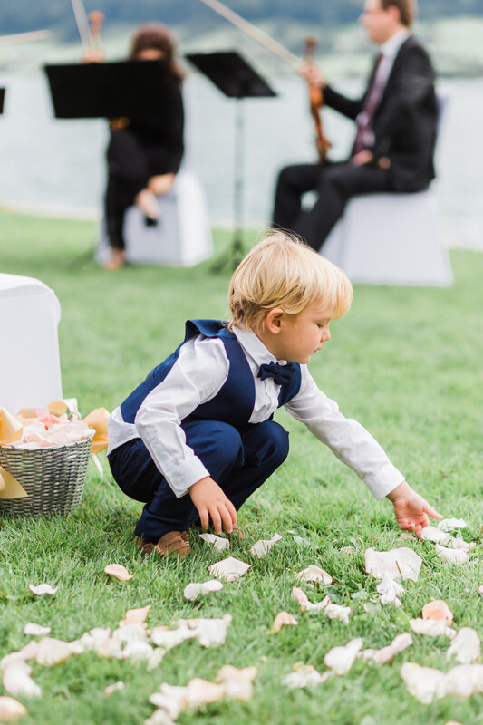 Wedding photography portfolio in Italy: Little boy scatters rose petals at a wedding ceremony