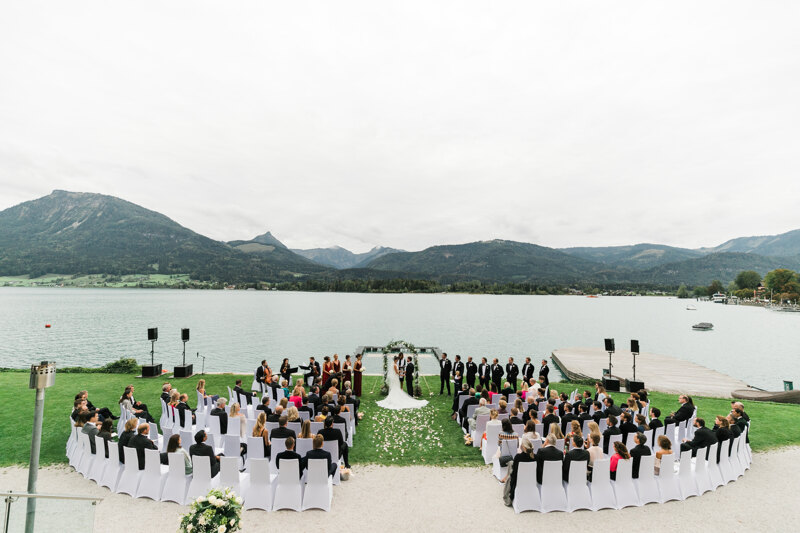 Wedding photography portfolio in Italy: Beautiful wedding ceremony on the shore of a mountain lake, the bride and groom are standing at the altar