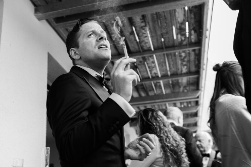 Wedding photography portfolio in Italy: Guest smokes a cigarette on the hotel terrace