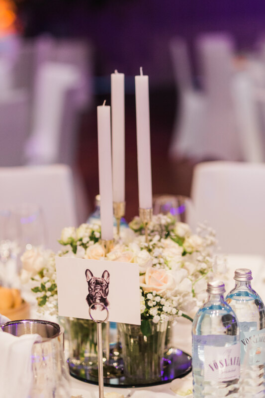 Wedding photography portfolio in Italy: Candlestick with candles and a delicate arrangement of flowers on the guest table
