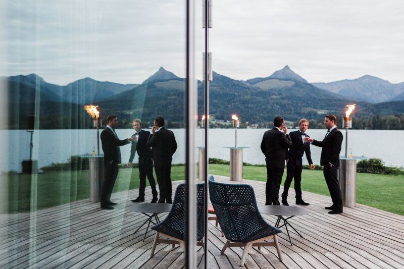 Wedding photography portfolio in Italy: Groom with friends stands on the terrace near the hotel