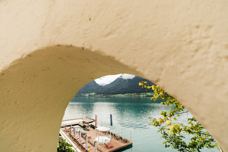 Wedding photography portfolio in Italy: Beautiful mountain lake with a small pier and sun loungers